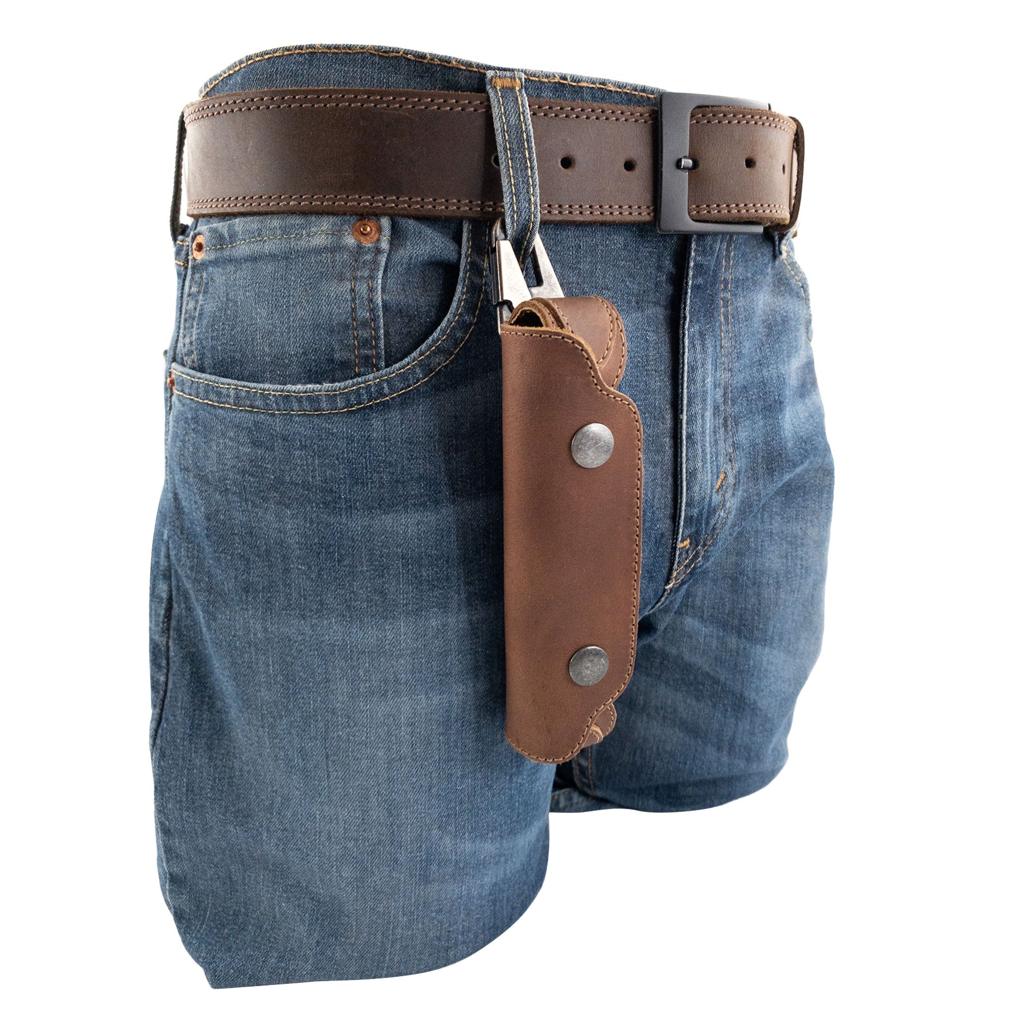 Harmonica Case from Hide & Drink hanging from a belt, emphasizing convenience for musicians on the go. Crafted from durable full grain leather, this vintage style protector ensures both style and functionality.