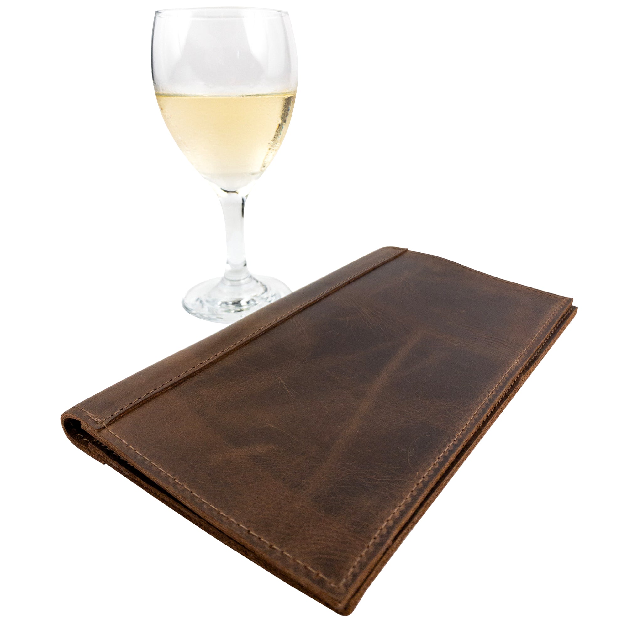 Fancy Check Presenter displayed alongside a glass of wine, featuring a rich Full Grain Leather exterior by Hide & Drink. This handmade bill holder for waiters and waitresses is perfect for adding a rustic touch to any dining experience.