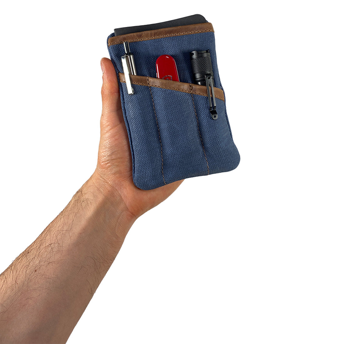 Person holding the blue Multi-tool Pocket Pouch by Hide & Drink, highlighting its efficient design and artisanal quality suitable for daily use.