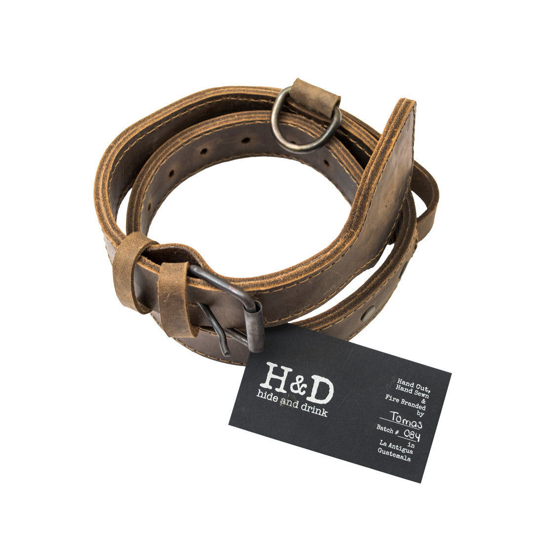 Thick Leather Dog Collar from Hide & Drink, elegantly presented with a tag. This handmade collar, designed for medium to large dogs (21 to 26 inches), is crafted from full grain leather and features durable rustic metal hardware, reflecting the care of artisan small batch production, hand-cut and sewn in La Antigua Guatemala & Oaxaca Mexico.