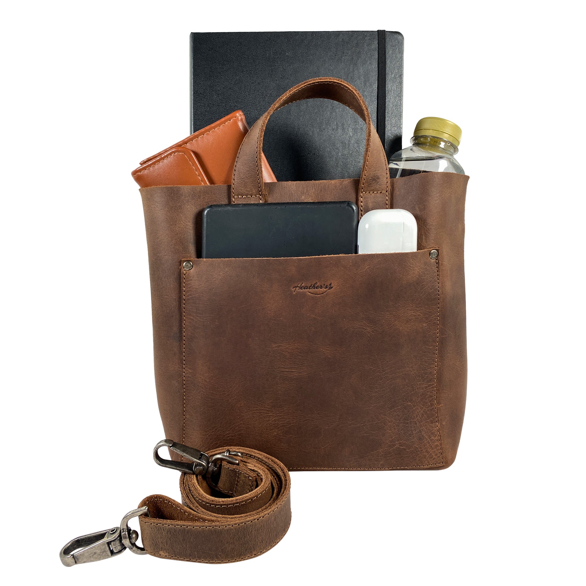 Heather's Crossbody Tote Bag with Pouch, filled with essentials for a day out, demonstrating its functionality as a classy purse. Made from high-quality full grain leather, this vintage style shoulder case is an artisan creation, handmade in La Antigua Guatemala & Oaxaca Mexico.