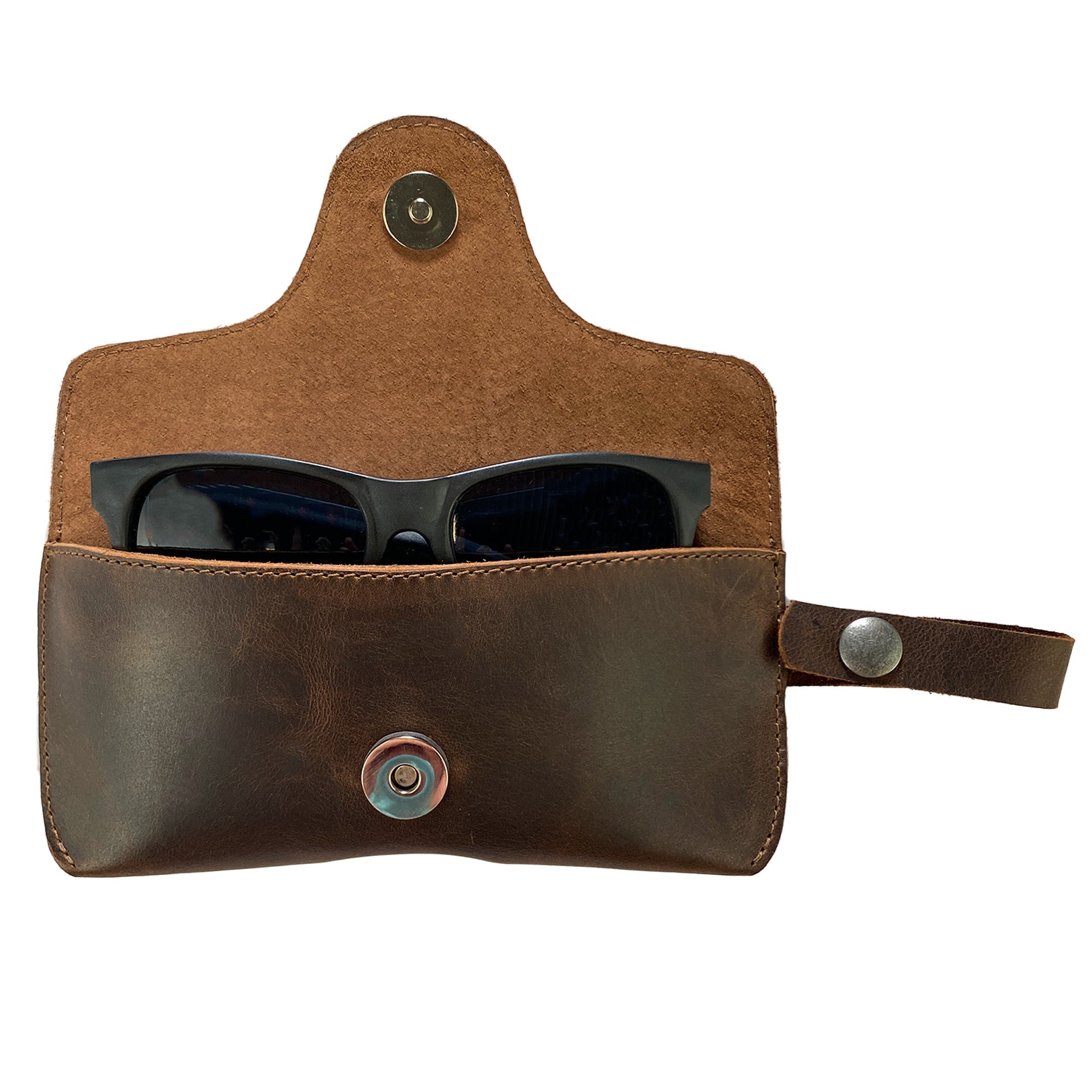 Closed Eyeglasses Case with Strap from Hide & Drink, perfect for sunglasses storage, made from robust full grain leather. This handmade protector for eyewear reflects a commitment to quality through small batch production in La Antigua Guatemala & Oaxaca Mexico.