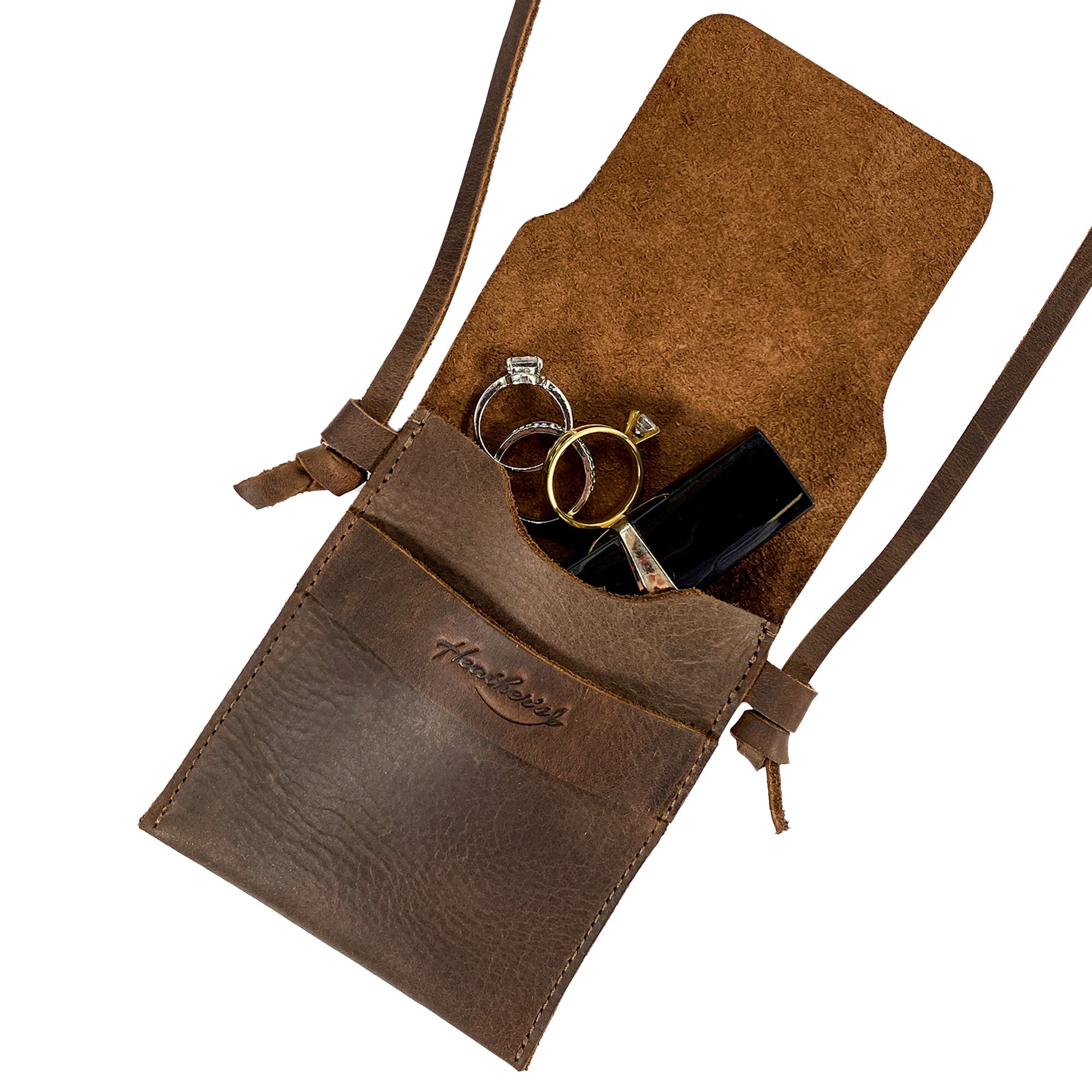 Mini Travel Bag by Heather's with rings and a lipstick inside, showcasing its storage capabilities. This Mini Travel Bag Handmade from Full Grain Leather is a classic organizer, coin pouch, and storage case for ID, credit cards, and cash. StockyardX, Small Batch Production, Hand Cut, Hand Sewn, Fire Branded, Artisan, Handmade in La Antigua Guatemala & Oaxaca Mexico.