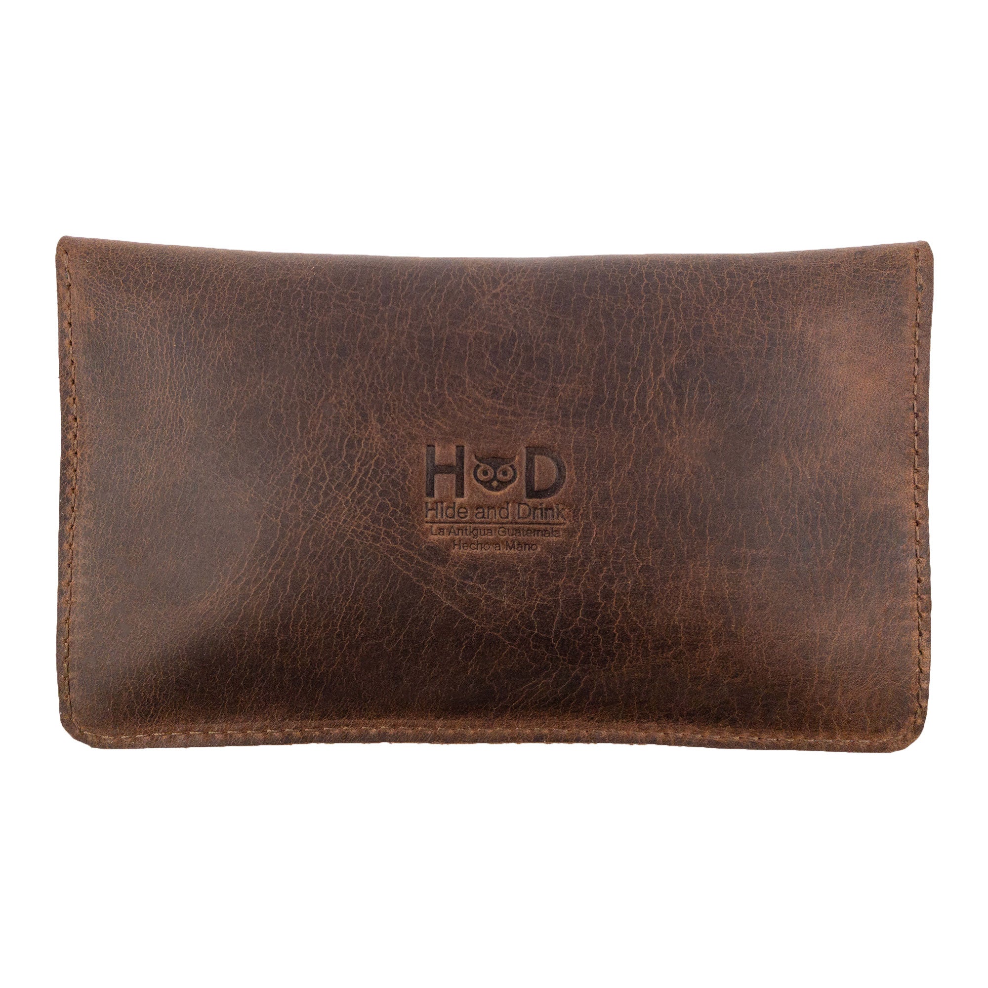 Back view of the Double Snap Tobacco Pouch by Hide & Drink, highlighting the elegant texture of full grain leather. This smoking case combines functionality with classic style, perfect for all your travel accessory needs. Hand cut and hand sewn, its fire branded logo reflects quality craftsmanship from Oaxaca Mexico.