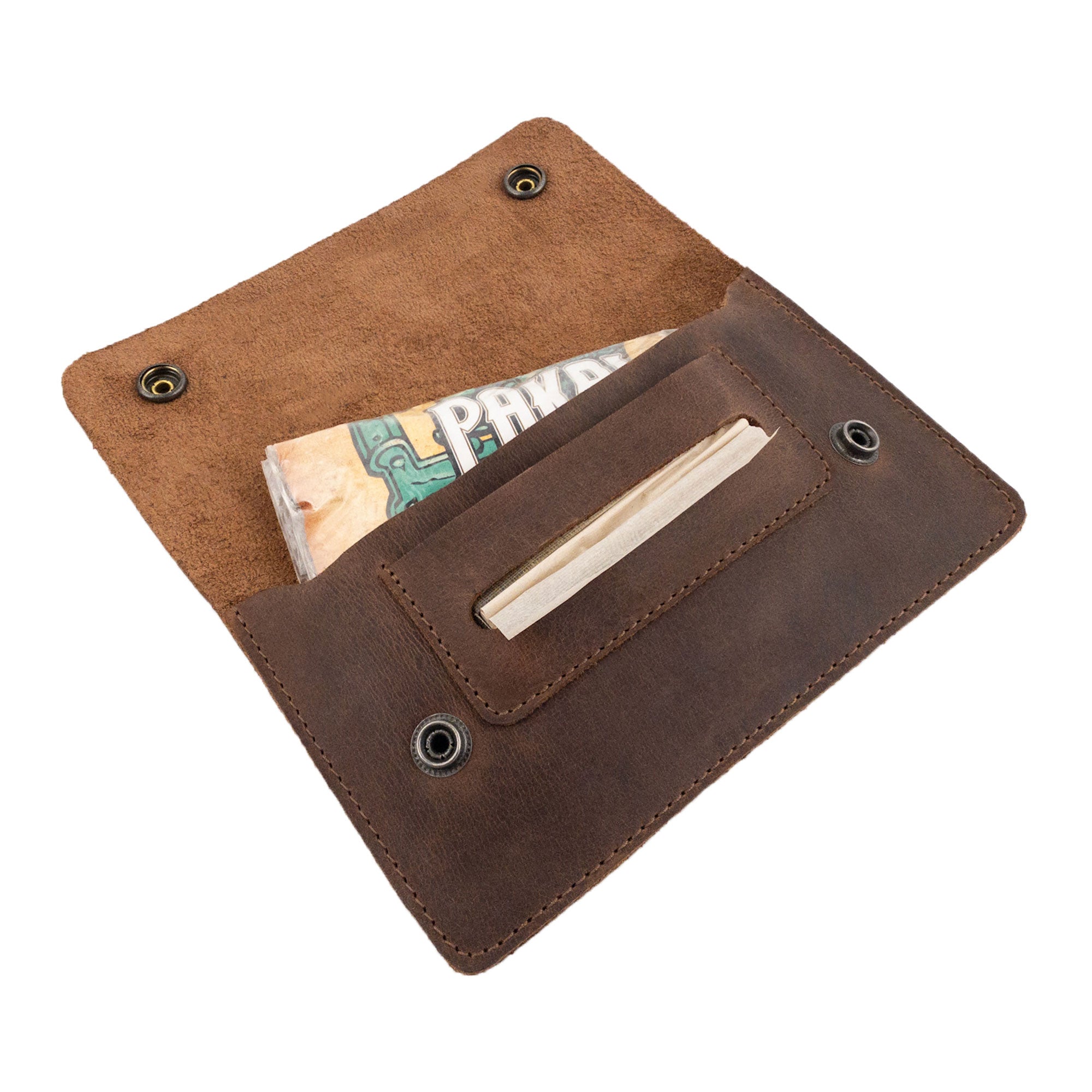 Opened Double Snap Tobacco Pouch by Hide & Drink, featuring practical storage for rolling papers and tobacco. This handmade smoking case offers a flat design, perfect for travel. Made from durable full grain leather, it exemplifies artisan quality from small batch production in La Antigua Guatemala.