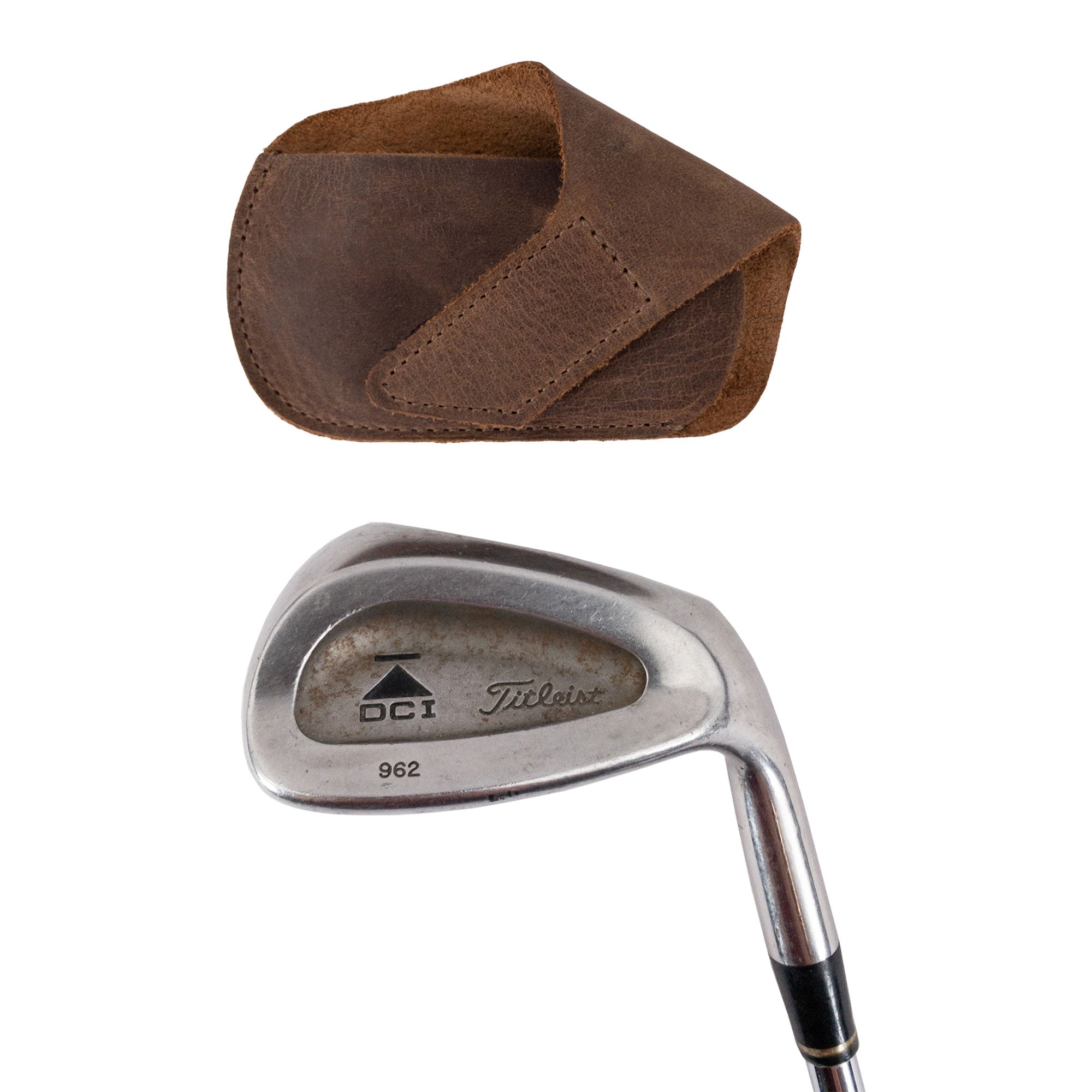 Hide & Drink Golf Club Cover alongside a Titleist DCI golf iron, demonstrating its function as a durable iron head protector. Made from full grain leather, this compact accessory is suitable for outdoor use. Handmade in La Antigua Guatemala, this artisan golf club headcover is fire branded and crafted with precision in small batches.