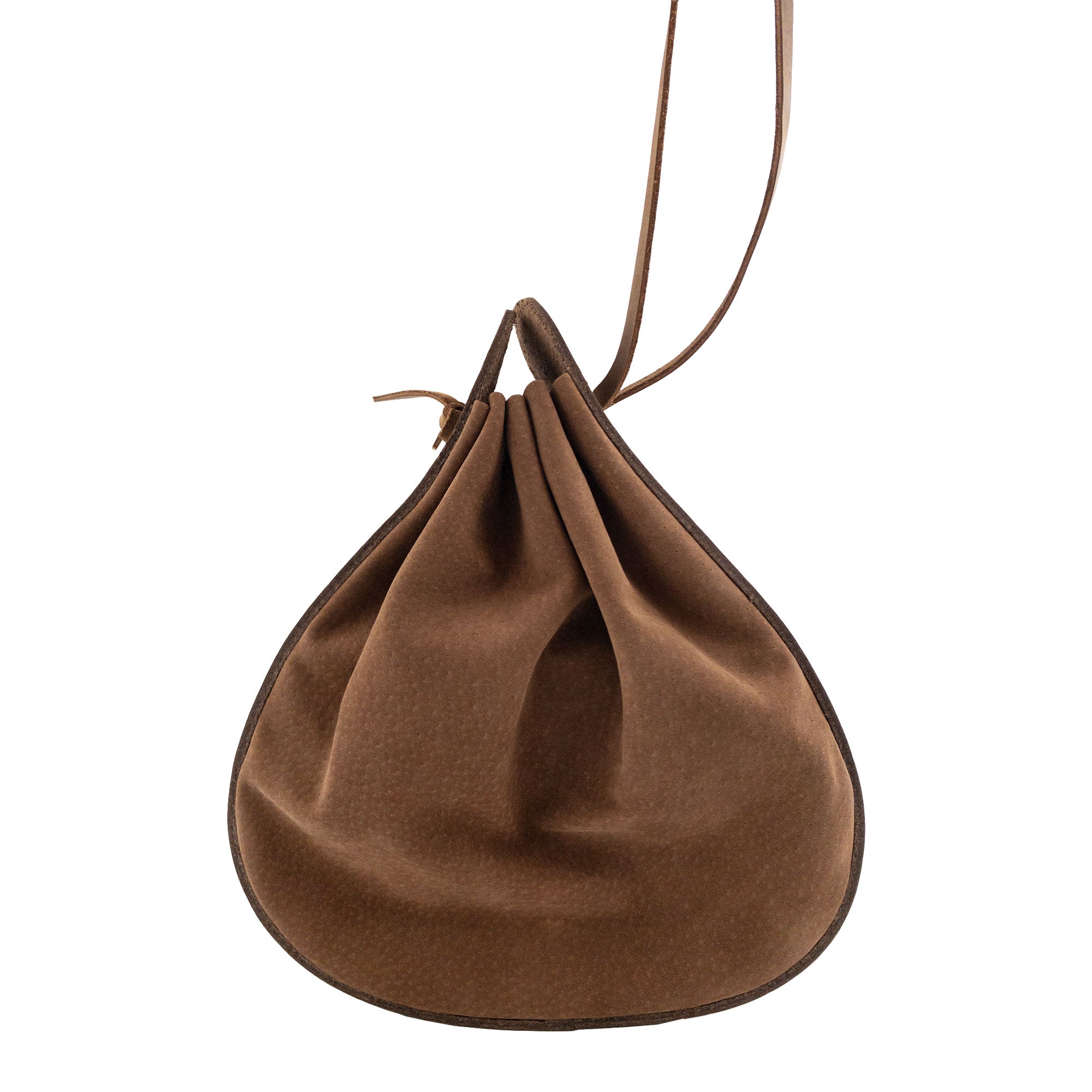 View of Heather's Shoulder Bag, showcasing its rounded design and closure technique. This multipurpose shoulder bag, made from durable full grain leather, is perfect for travel. The product highlights artisan craftsmanship with small batch production, hand cut and hand sewn details, and is fire branded, handmade in La Antigua Guatemala & Oaxaca Mexico.