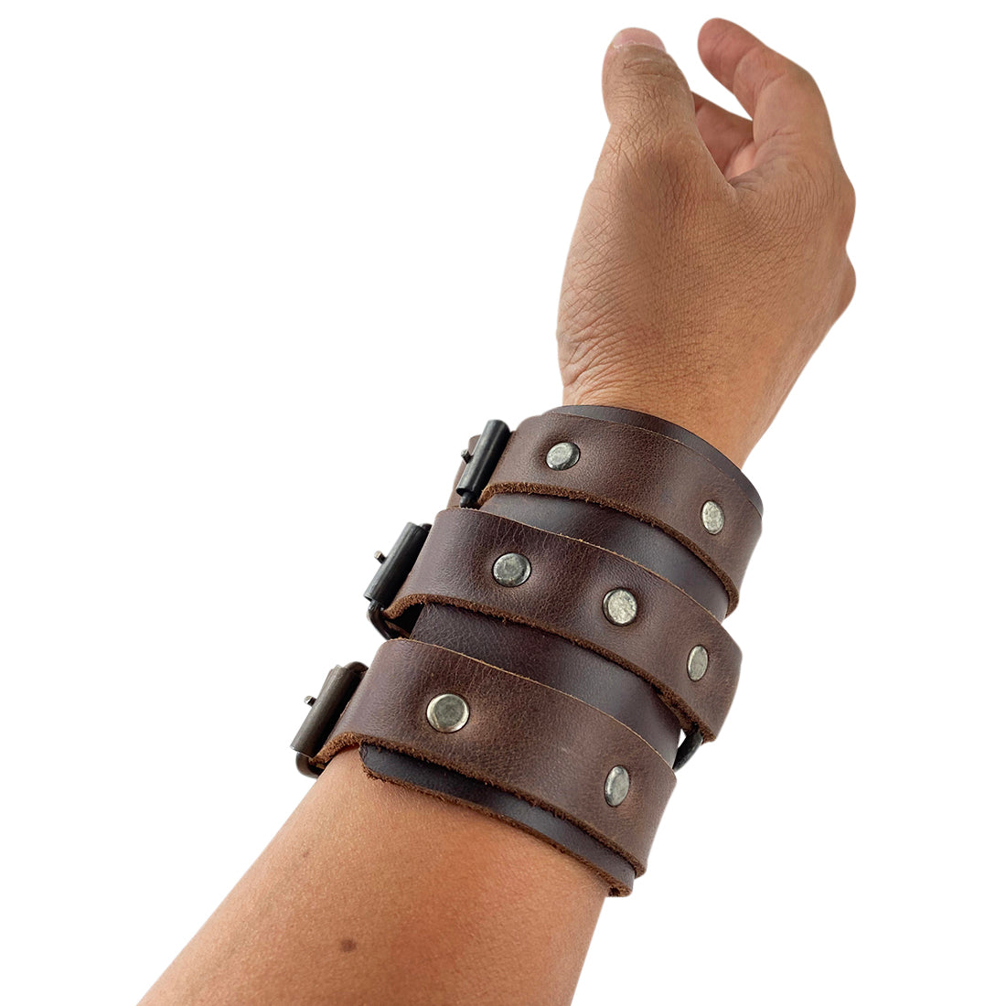 The 3 Buckle Bracelet by Hide & Drink worn on a wrist, showing off its trendy design and robust leather. This fashionable accessory is handcrafted, adjustable, and perfect for men seeking a stylish and durable full grain leather cuff.
