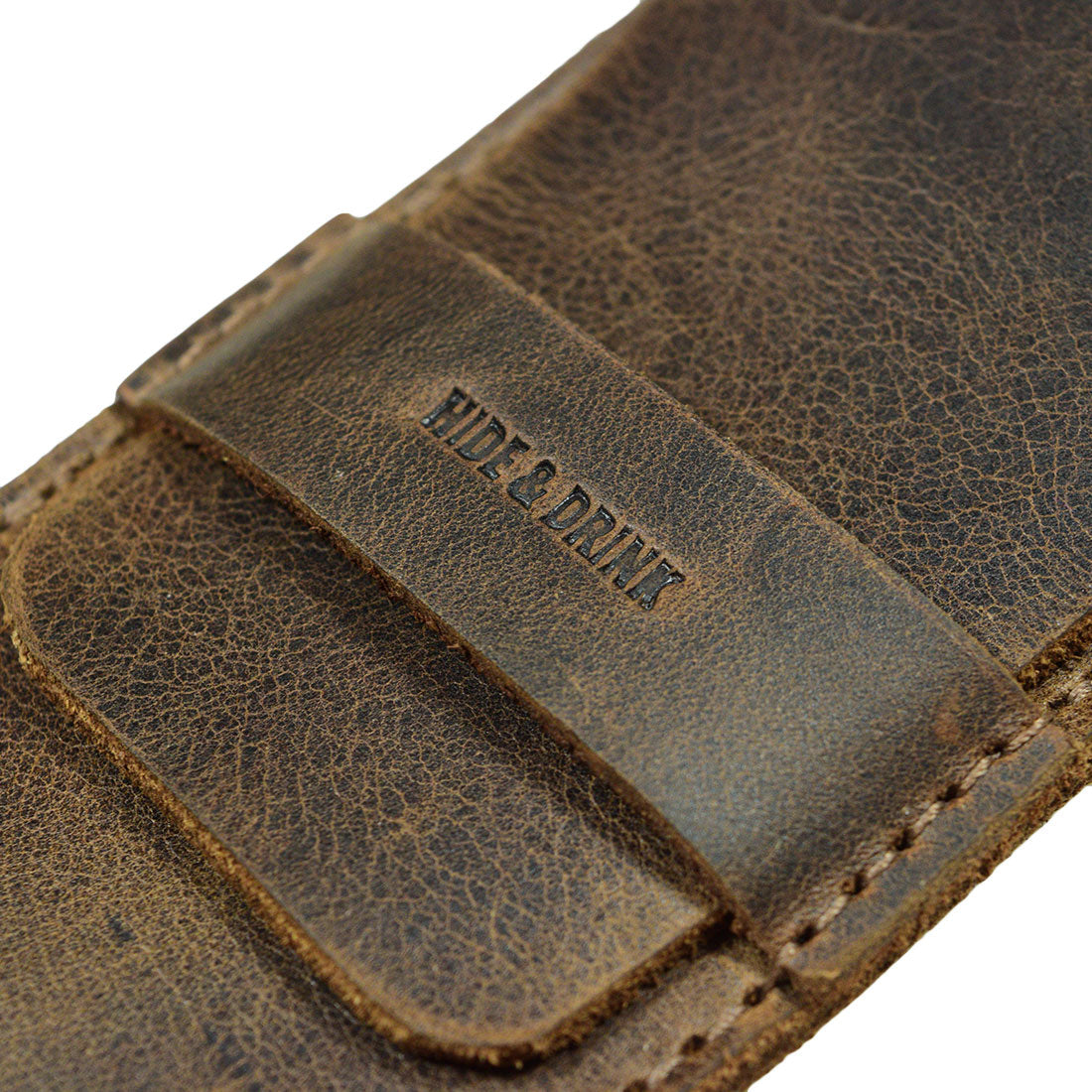 An up-close image of the Hide & Drink Pen Case's branding. This Pen Case Holder intricately showcases the fine craftsmanship. An excellent Multi Pen Pouch, it’s made from durable Full Grain Leather that emphasizes StockyardX’s dedication to small batch production. With hand cut and hand sewn details, the fire branded logo signifies true artisan quality from La Antigua Guatemala & Oaxaca Mexico.