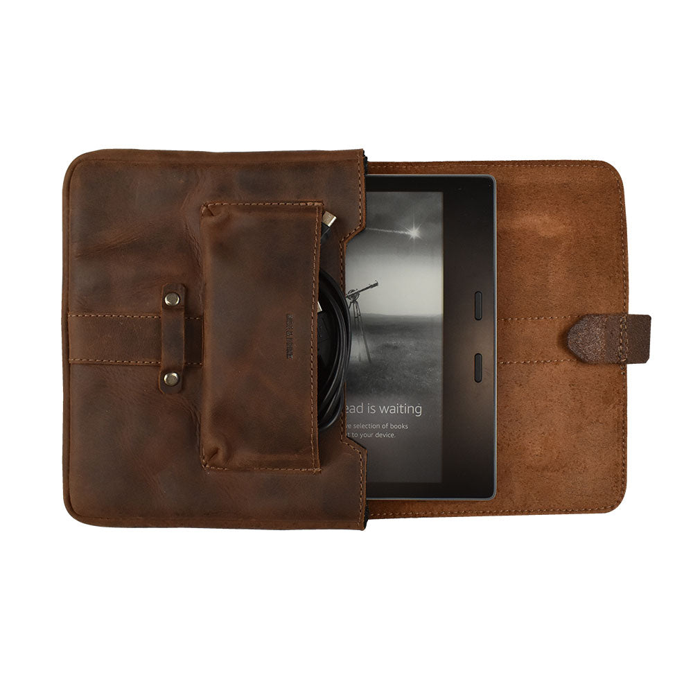 Kindle Oasis Sleeve by Hide & Drink with tablet inside, highlighting its protective features in luxurious full grain leather. This handmade protector cover is ideal for travel, reflecting artisan quality from La Antigua Guatemala & Oaxaca Mexico.