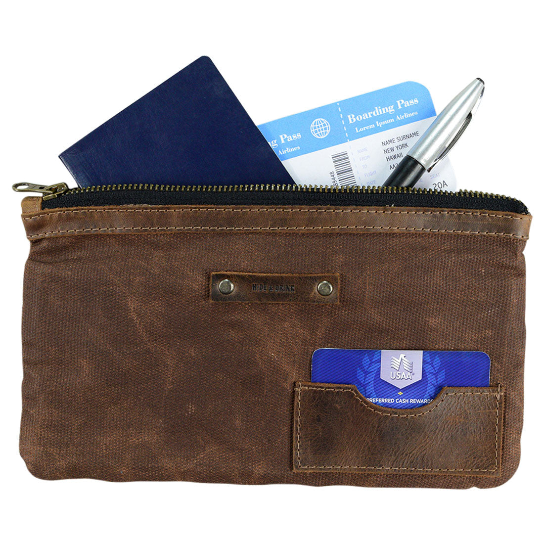 Traveler Organizer by Hide & Drink filled with travel essentials, illustrating its functionality as an All Purpose Utility Pouch. Made from Waxed Canvas & Full Grain Leather, this versatile Travel Accessories item is a must-have for camping organization. Artisan crafted in Small Batch Production, it highlights the skill of handcut and handsewn workmanship from La Antigua Guatemala & Oaxaca Mexico.