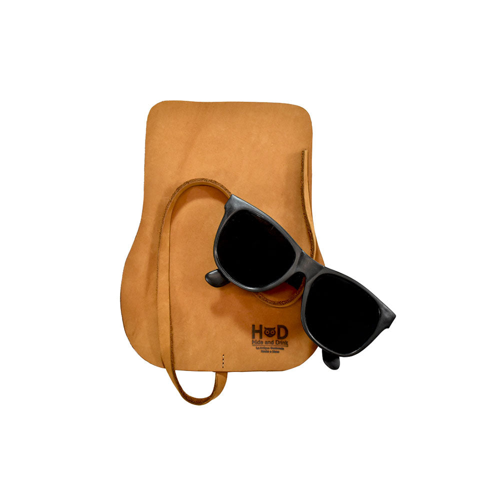 Hide & Drink Sunglass Wrap provides a stylish solution for eye glasses storage. Made from full grain leather, it offers durability and elegance for travel. Hand cut and sewn, each piece is crafted in La Antigua Guatemala.