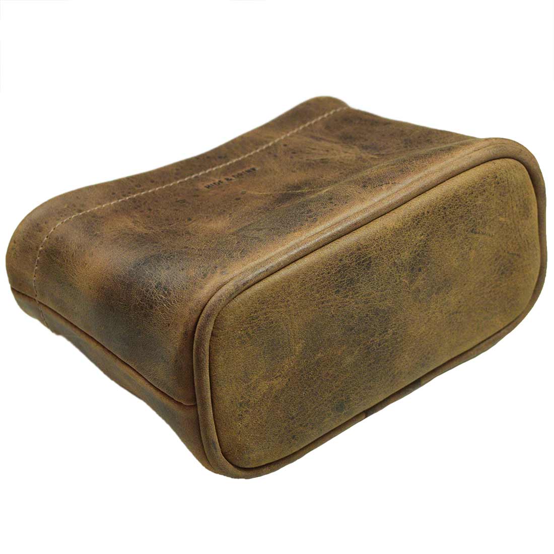 An underside view of Hide & Drink's rustic Desk Organizer Bag, illustrating the fine leather construction. This pen holder is a perfect accessory for any workspace, celebrating small batch production and being handmade in La Antigua Guatemala & Oaxaca Mexico.