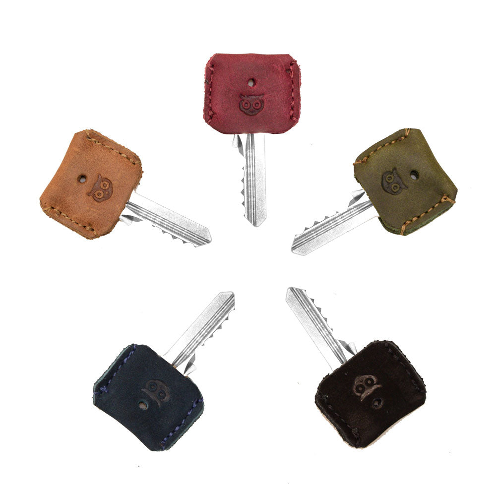 Various Key Covers from Hide & Drink in a set of 5, emphasizing their distinct leather craftsmanship. These key protectors are made from full grain leather, showcasing small batch production artistry with meticulous hand cut and hand sewn designs, crafted in La Antigua Guatemala & Oaxaca Mexico.