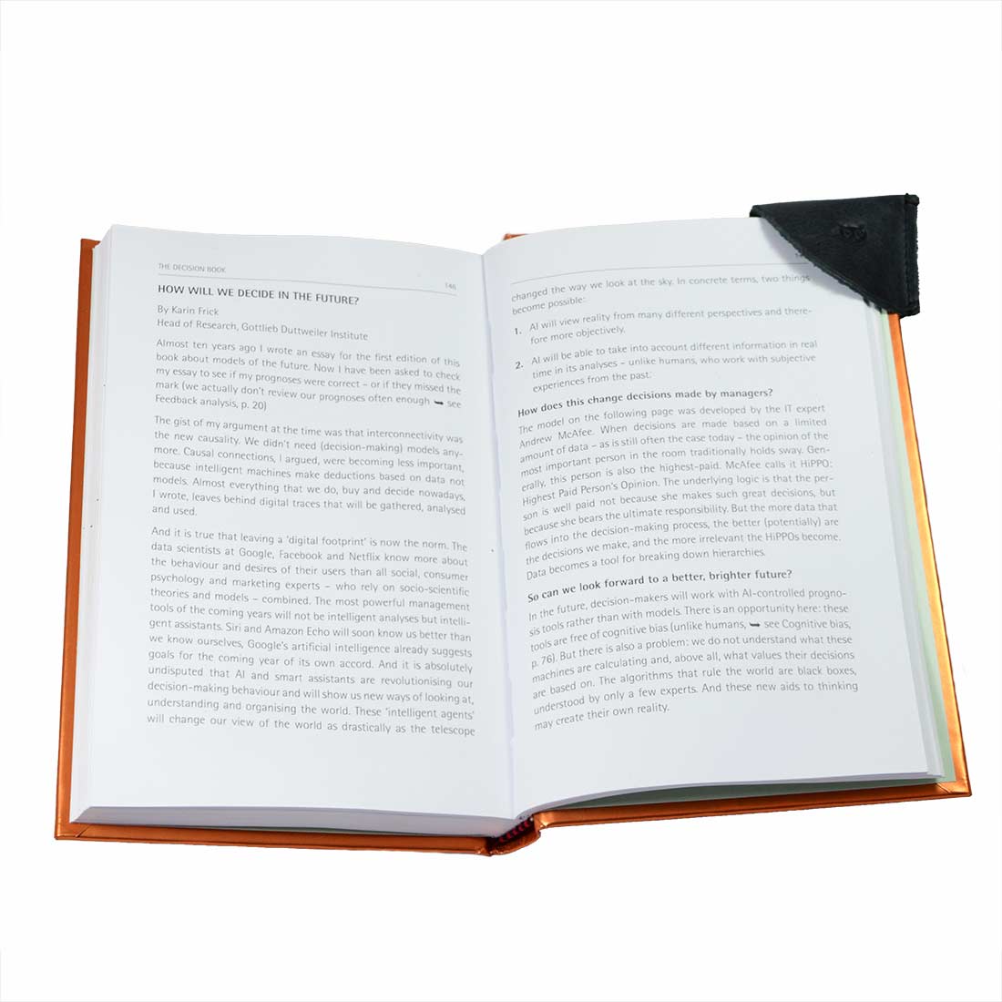Practical leather corner bookmark from Hide & Drink, featured in the Corner Bookmark 3-Pack, set inside an open book. This full grain leather bookmark is a stylish way to mark your place, made with artisan skills including small batch production, hand cut, hand sewn, and fire branded in La Antigua Guatemala & Oaxaca Mexico.