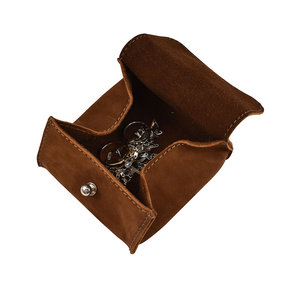 Open with rings inside a Hide & Drink Jewelry Pouch, emphasizing its role as a rings and precious articles storage organizer. This artisan-made pouch in full grain leather is perfect for those seeking stylish gifts for wedding parties.