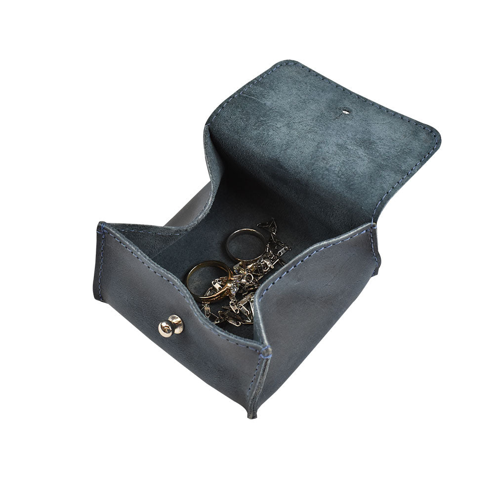 Interior of a Hide & Drink Jewelry Pouch filled with jewelry, emphasizing its utility as a storage organizer. This artisan-made leather piece is ideal for wedding celebrations.