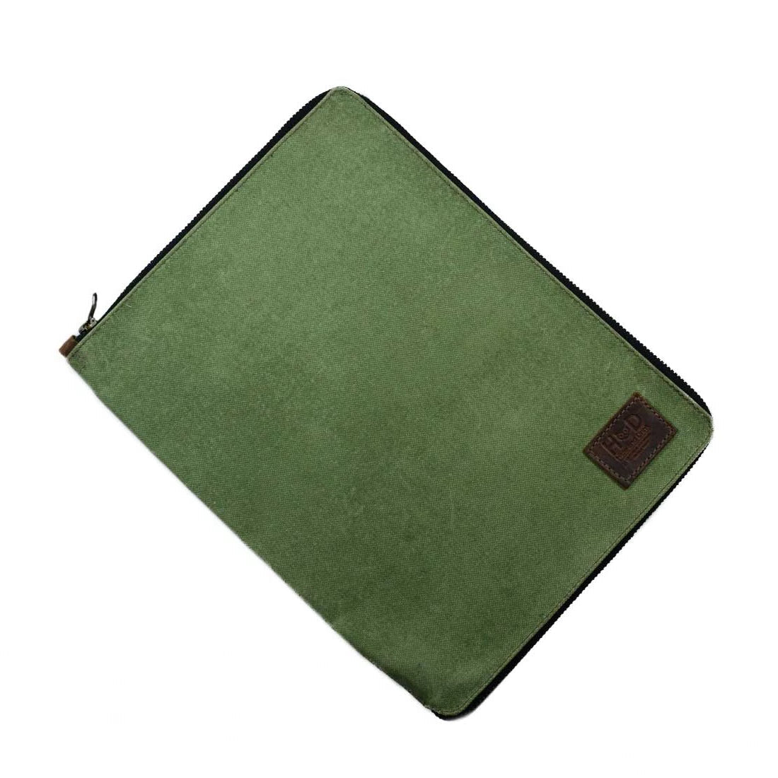 Front view of the Waxed Canvas Zippered Journal Cover for Moleskine (Notebook NOT Included) by Hide & Drink, highlighting the green Waxed Canvas and Full Grain Leather features. A perfect Cahier Case for notes, handmade by artisans from La Antigua Guatemala & Oaxaca Mexico.