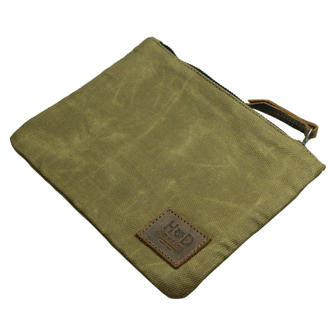An empty Waxed Zippered Pouch by Hide & Drink in olive green, highlighting its lightweight case design. This multifunctional bag is crafted from waxed canvas and full grain leather, representing small batch production and artisan quality.
