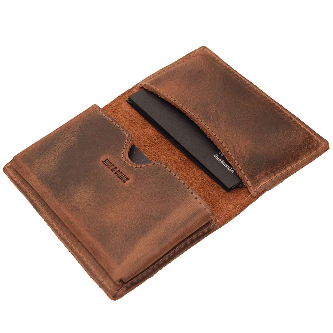 Hide & Drink's Vintage Card Holder opened with business cards fitted, showcasing its practicality as a cash organizer and wallet. This handmade item is crafted from full grain leather as part of a small batch production process in La Antigua Guatemala & Oaxaca Mexico, reflecting true artisan skill.