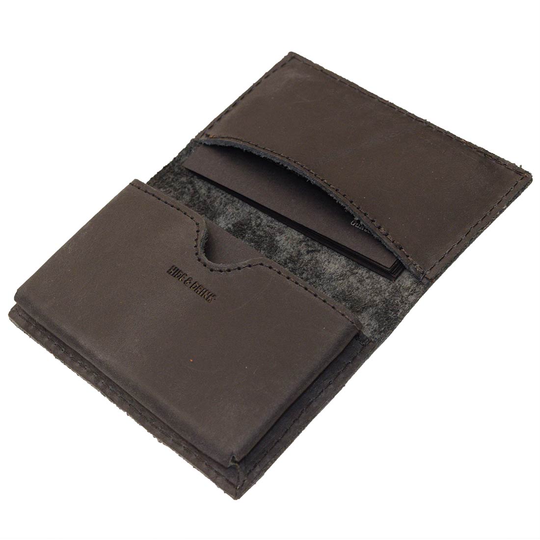 Inside view of Hide & Drink's Vintage Card Holder displaying its functionality with business cards and cash. This handcrafted wallet is made from high-quality full grain leather as part of small batch production by artisans in La Antigua Guatemala & Oaxaca Mexico.