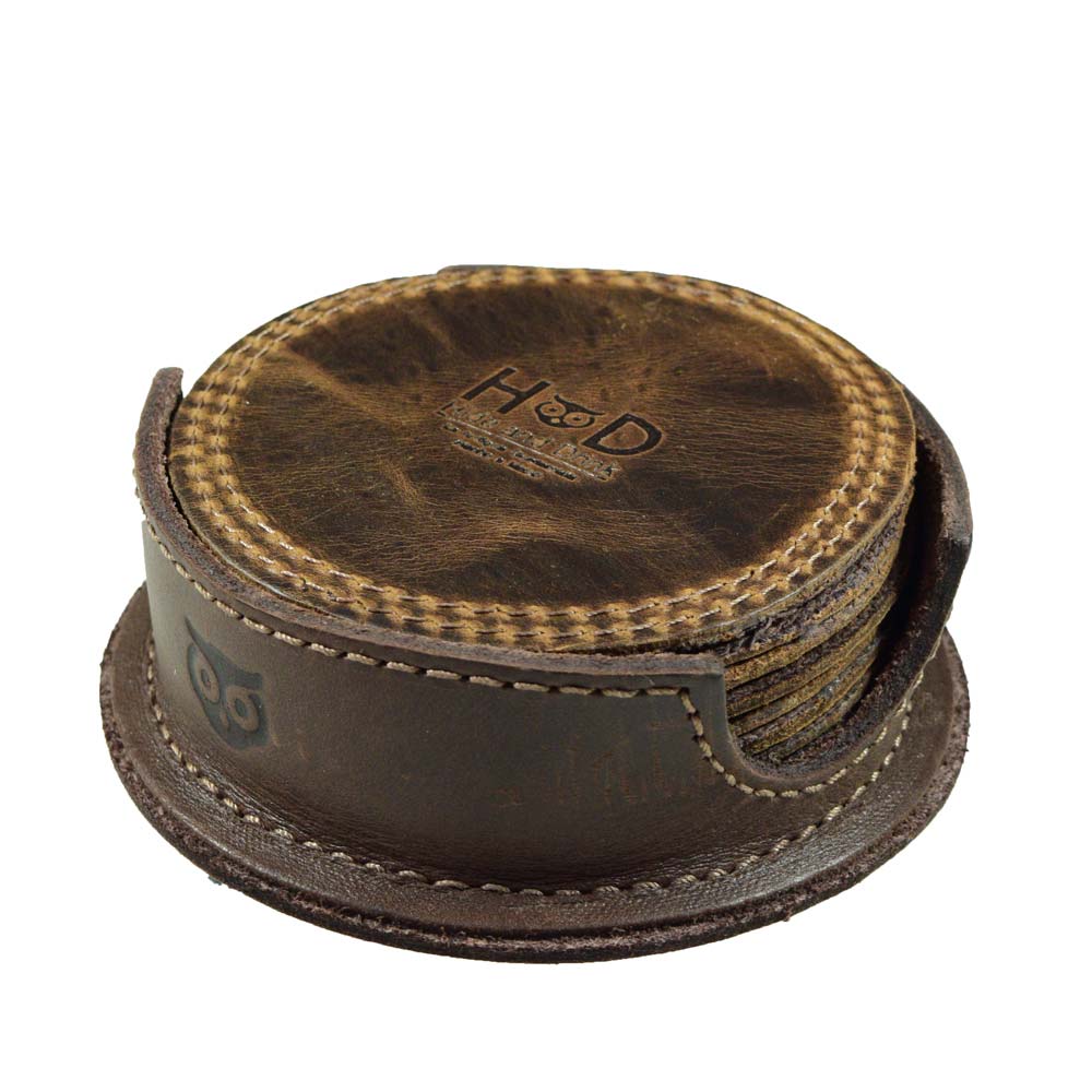 Displaying the Circles Coaster (8-Pack) by Hide & Drink, where you can see a complete set of 8 hand cut and hand sewn coasters, beautifully housed in a full grain leather holder. These coasters are perfect for adding protection to any surface in your home or kitchen.