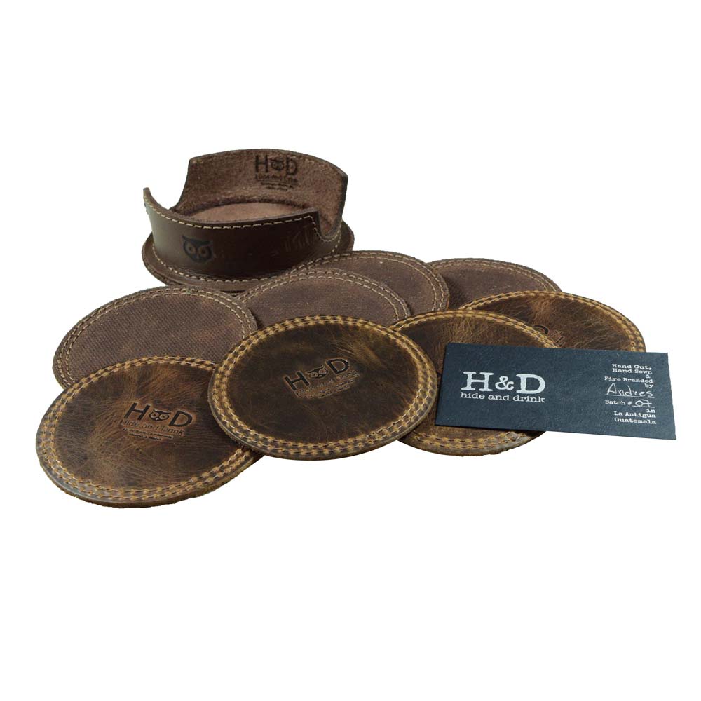 Circles Coaster (8-Pack) by Hide & Drink featuring a set of 8 durable waxed canvas and full grain leather all-round coasters designed for table, home, office, bar, or kitchen use. These coasters provide stain protection for glasses and cups and come with a deep tray holder. Each piece is crafted with care through small batch production, hand cut, hand sewn, and fire branded, showcasing artisan craftsmanship and handmade quality from La Antigua Guatemala & Oaxaca Mexico.