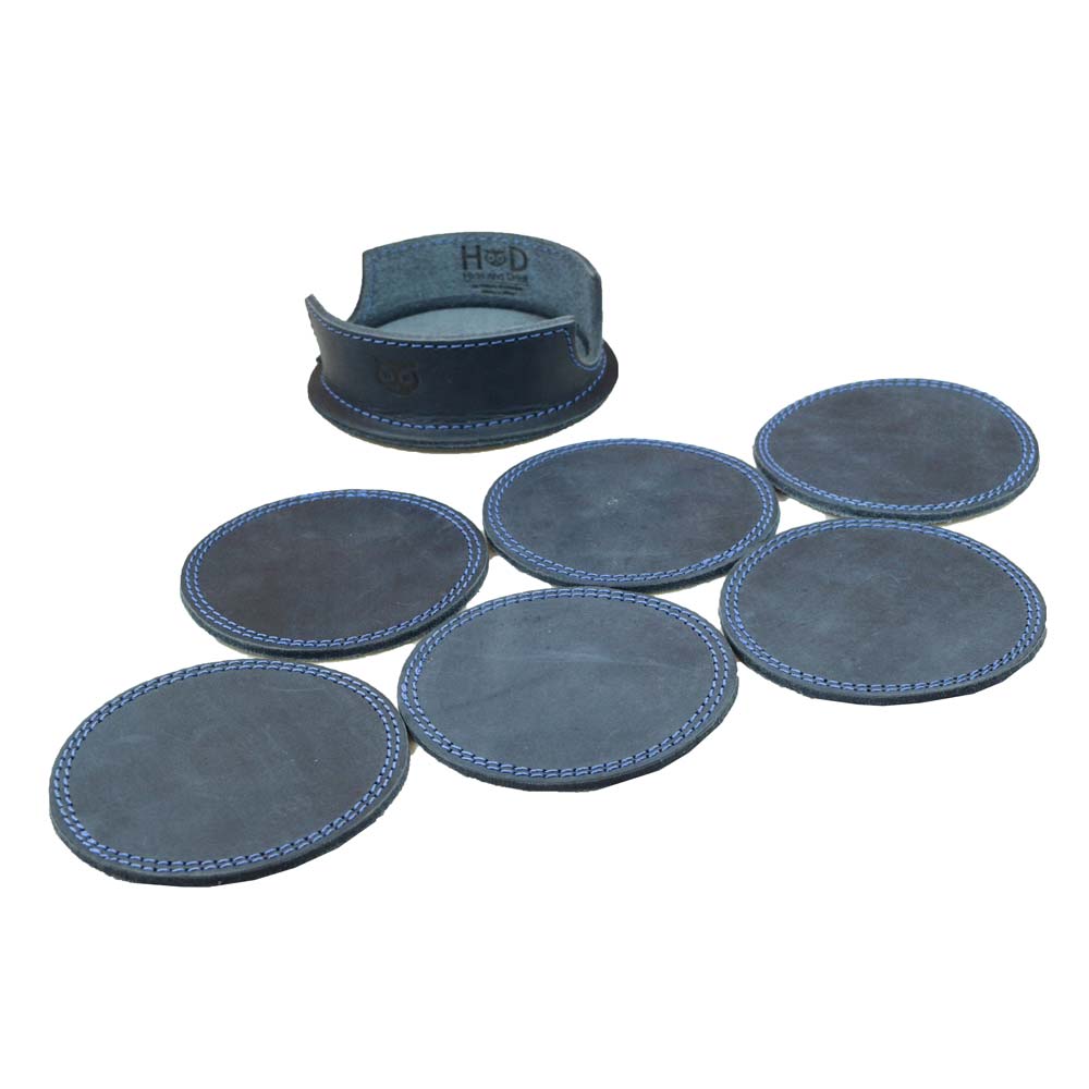 Thick Leather Coasters (6-Pack) by Hide & Drink showing multiple circular coasters in blue slate, underlining the quality of full grain leather used. This artisan collection features small batch production, with each piece hand cut, hand sewn, and fire branded, proudly handmade in La Antigua Guatemala.