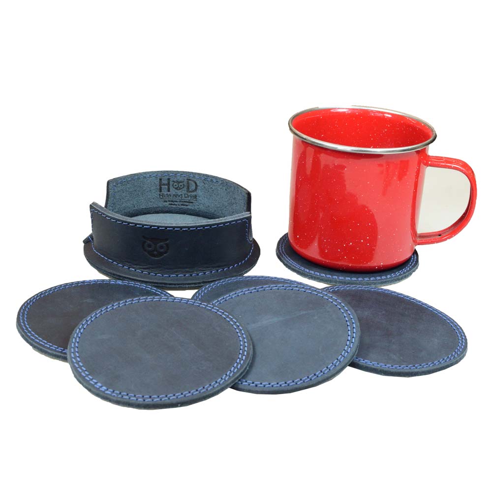 Thick Leather Coasters (6-Pack) by Hide & Drink with a red enamel mug, perfect for drinks, made from high-quality blue slate leather. These circular coasters showcase artisan craftsmanship featuring small batch production, hand cut, hand sewn, and fire branded, created in La Antigua Guatemala.