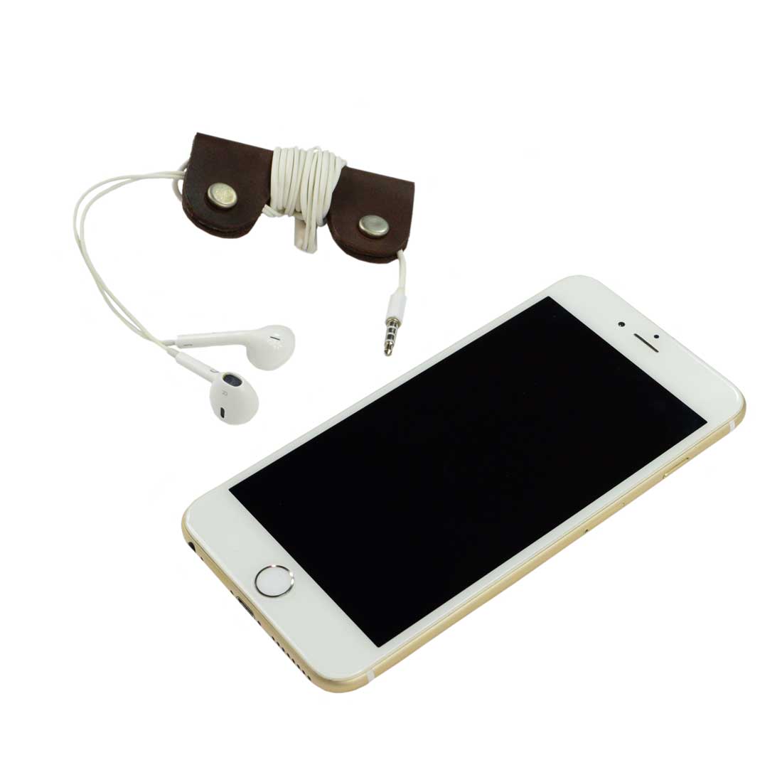 The Wrap Cord Keeper by Hide & Drink displayed alongside a smartphone, illustrating its functionality as a cable organizer holder. Made from full grain leather, this handmade accessory is crafted in small batches in La Antigua Guatemala & Oaxaca Mexico.