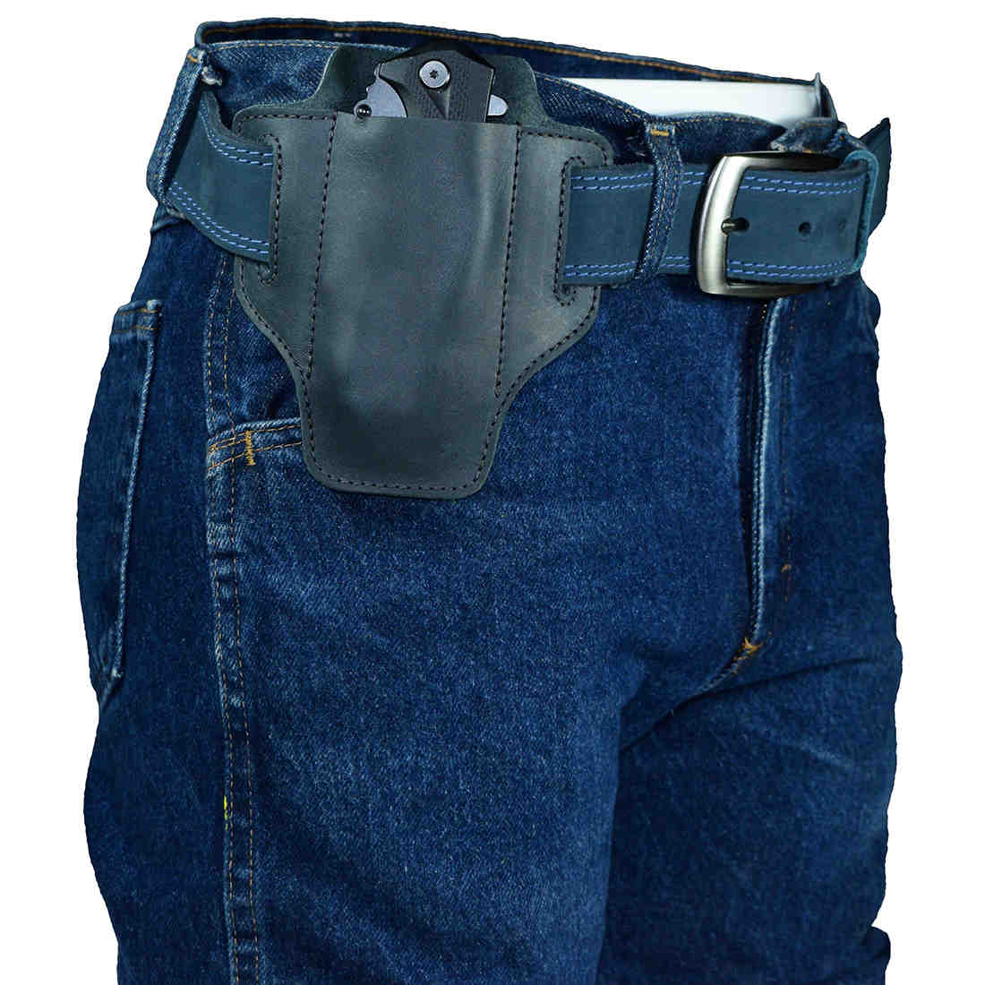 An outdoor perspective of Hide & Drink's Tactical Knife Holster attached to a belt, made from elegant black Full Grain Leather. This Tactical Knife Leather Holster offers practicality as a multitool holder for camping & outdoor accessories, handcrafted in La Antigua Guatemala & Oaxaca Mexico.