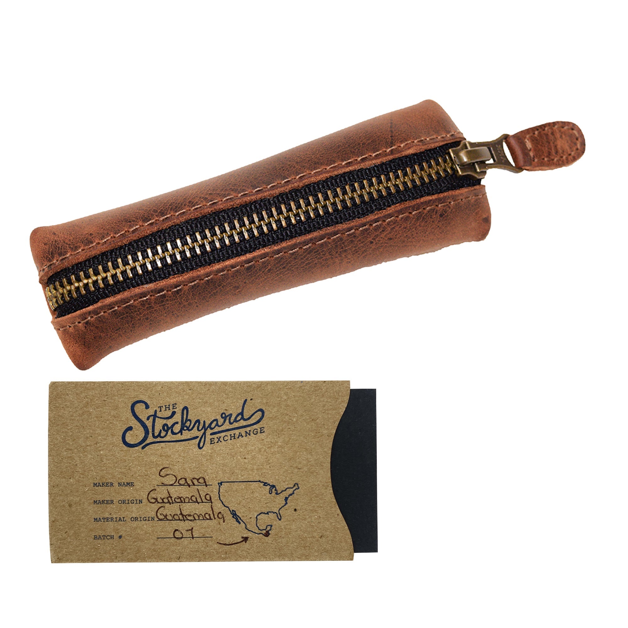 Hide & Drink Long Coin Organizer with accompanying artisan tag, emphasizing its craftsmanship and story. This quality item serves as a Long Coin Case, Cash Holder, and Rustic Case for Pennies, making it an ideal Vintage Zippered Pouch for travel. Crafted in full grain leather, it represents Small Batch Production, Hand Cut and Hand Sewn by skilled artisans, ensuring a unique Fire Branded design crafted in La Antigua Guatemala & Oaxaca Mexico.