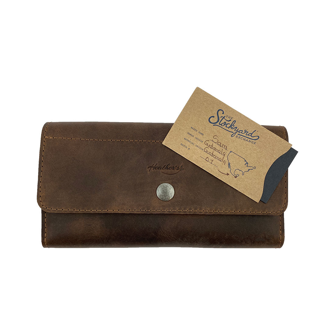 Detailed view of Heather's Tri Fold Folio Wallet, highlighting its elegant full grain leather texture and craftsmanship. This Tri Fold Folio Wallet is designed for women who appreciate minimalist style, featuring a secure button closure and made in small batches by artisans in La Antigua Guatemala & Oaxaca Mexico.