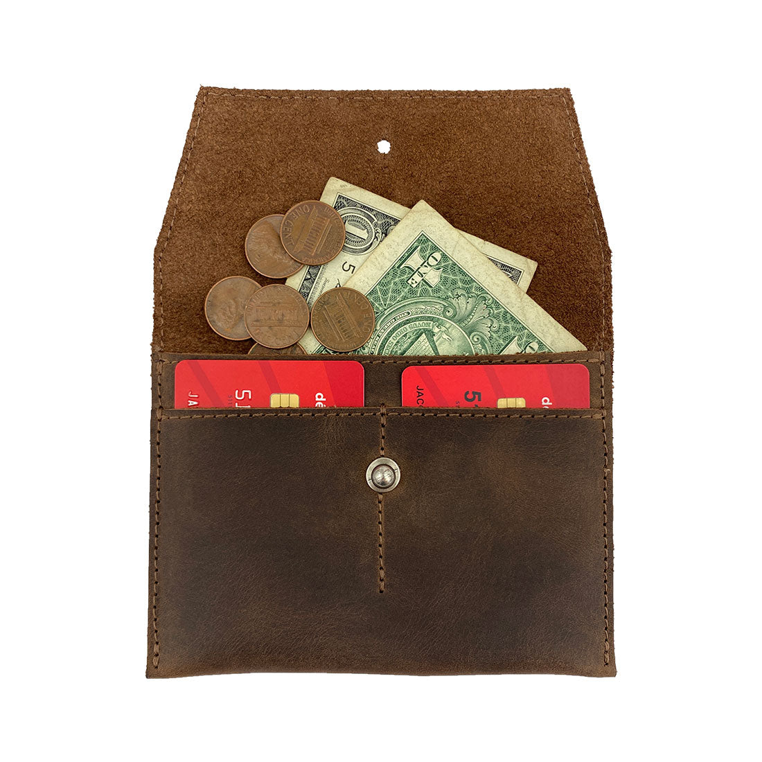Heather's Minimalist Wallet filled with cash and cards, showcasing its function as a durable cash organizer and card holder. This full grain leather wallet is perfect for everyday use and travel, highlighting small batch production and artisan craftsmanship. Handmade in La Antigua Guatemala & Oaxaca Mexico.