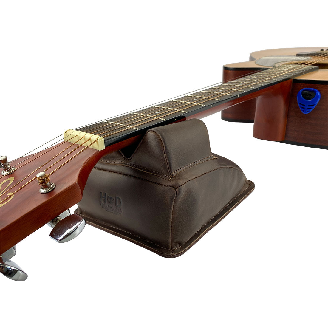 Hide & Drink Guitar Neck Rest supporting an acoustic guitar, designed for maintenance with full grain leather. This artisan handmade piece is perfect for string changing, repair, and cleaning care for musicians in La Antigua Guatemala & Oaxaca Mexico, showcasing its outstanding craftsmanship.