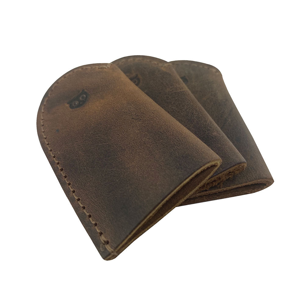 Leather Thimble for Thumb & Index Finger (3 Paires) by Hide & Drink displaying a trio of thimbles from the set of 3 pairs (6 pieces). These finger protectors are excellent for sewing, hand appliqué, EPP, and quilting, made from high-quality full grain leather. StockyardX showcases these artisan, handmade thimbles, painstakingly hand cut and hand sewn, with distinctive fire branded elements, crafted in La Antigua Guatemala & Oaxaca Mexico.