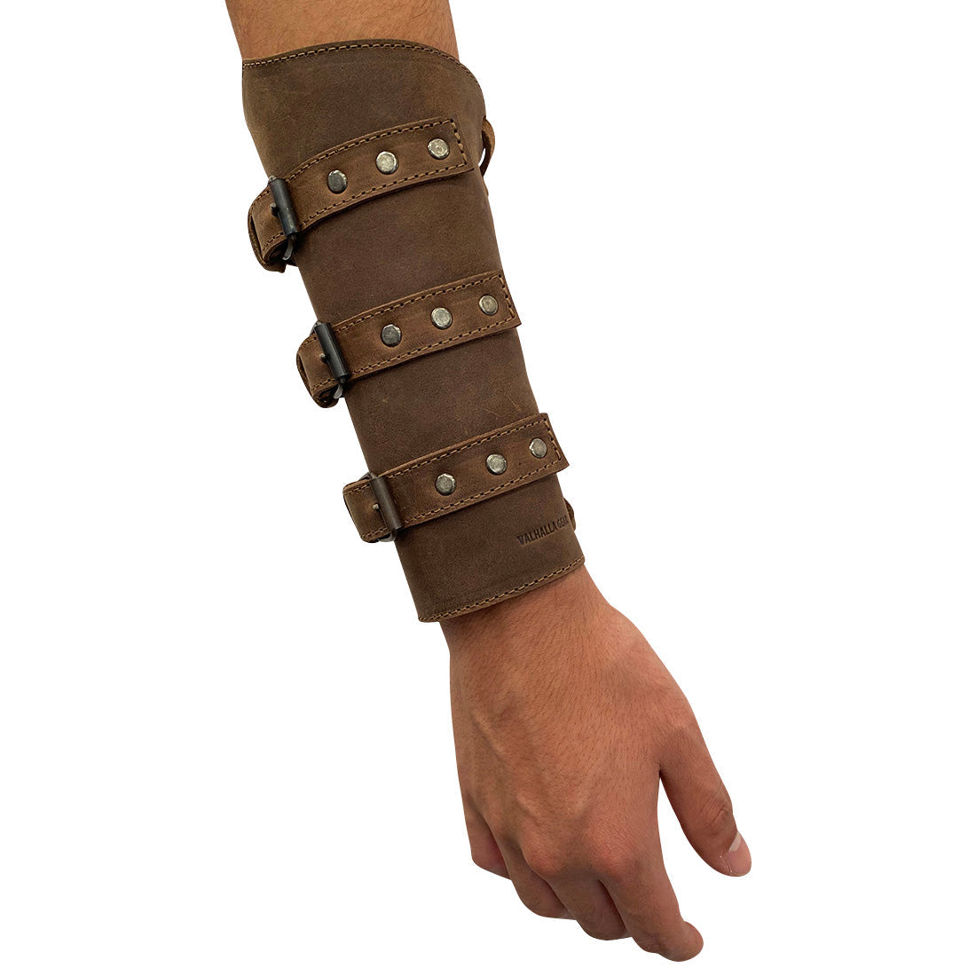Valhalla Gear Archery Buckle Bracer worn on a hand, illustrating the comfort and fit of the Set of 2 Archery Buckle Bracer. This adjustable wrist guard, made of high-quality full grain leather, serves as a perfect hand protector for bow shooting practice, representing small batch artisan production.