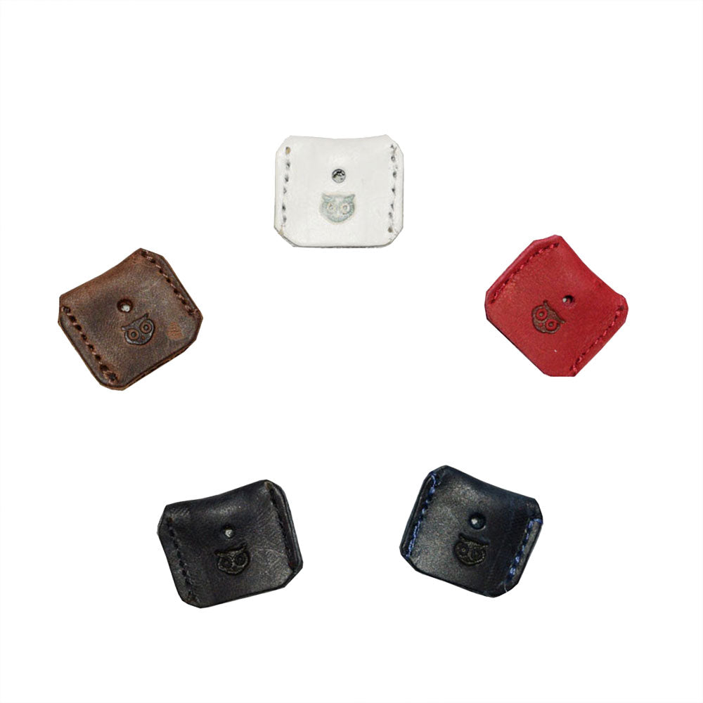 A colorful assortment of handmade Key Covers from Hide & Drink. These unique key protectors, made from full grain leather, highlight small batch production with hand cut, hand sewn, and fire branded styles, providing a stylish touch for keys, crafted in La Antigua Guatemala & Oaxaca Mexico.