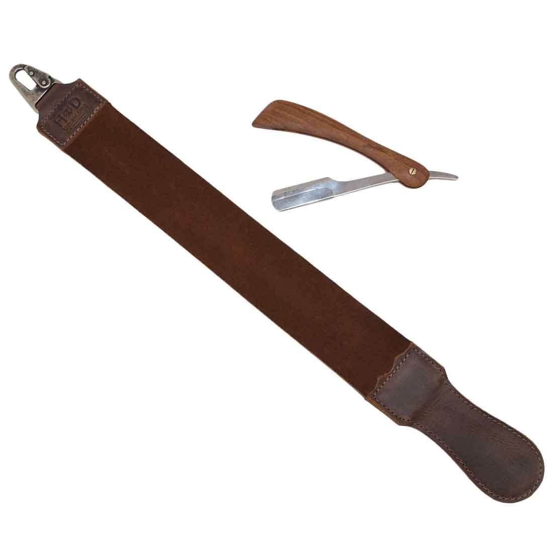Hide & Drink's Barber Strop displayed with a straight razor, showcasing stellar craftsmanship. This Full Grain Leather shaving sharpener serves as a Razor Strop and Barber Straight Razor Strap Belt, emphasizing artisan quality and handmade tradition.