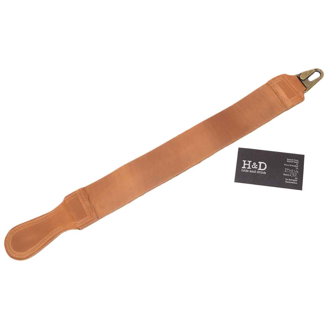 A gripping view of Hide & Drink's Barber Strop, showcasing its handmade quality. This Full Grain Leather shaving sharpener serves as an excellent Razor Strop, highlighting the craftsmanship of artisans.