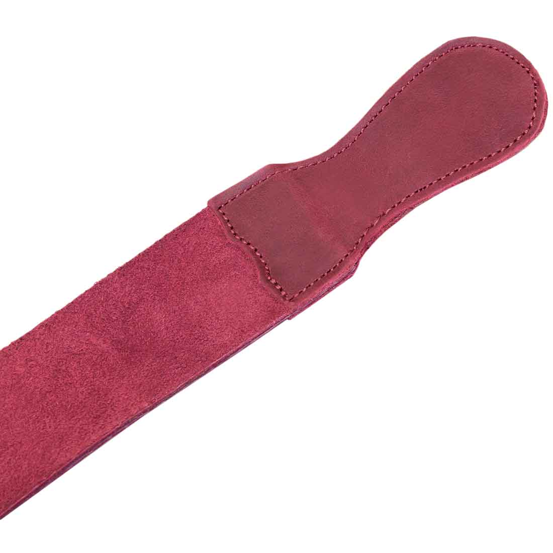 Close-up of the handle on Hide & Drink's purple Barber Strop, showcasing its robust Full Grain Leather design. This shaving sharpener serves as a Razor Strop emphasizing artisan craftsmanship.