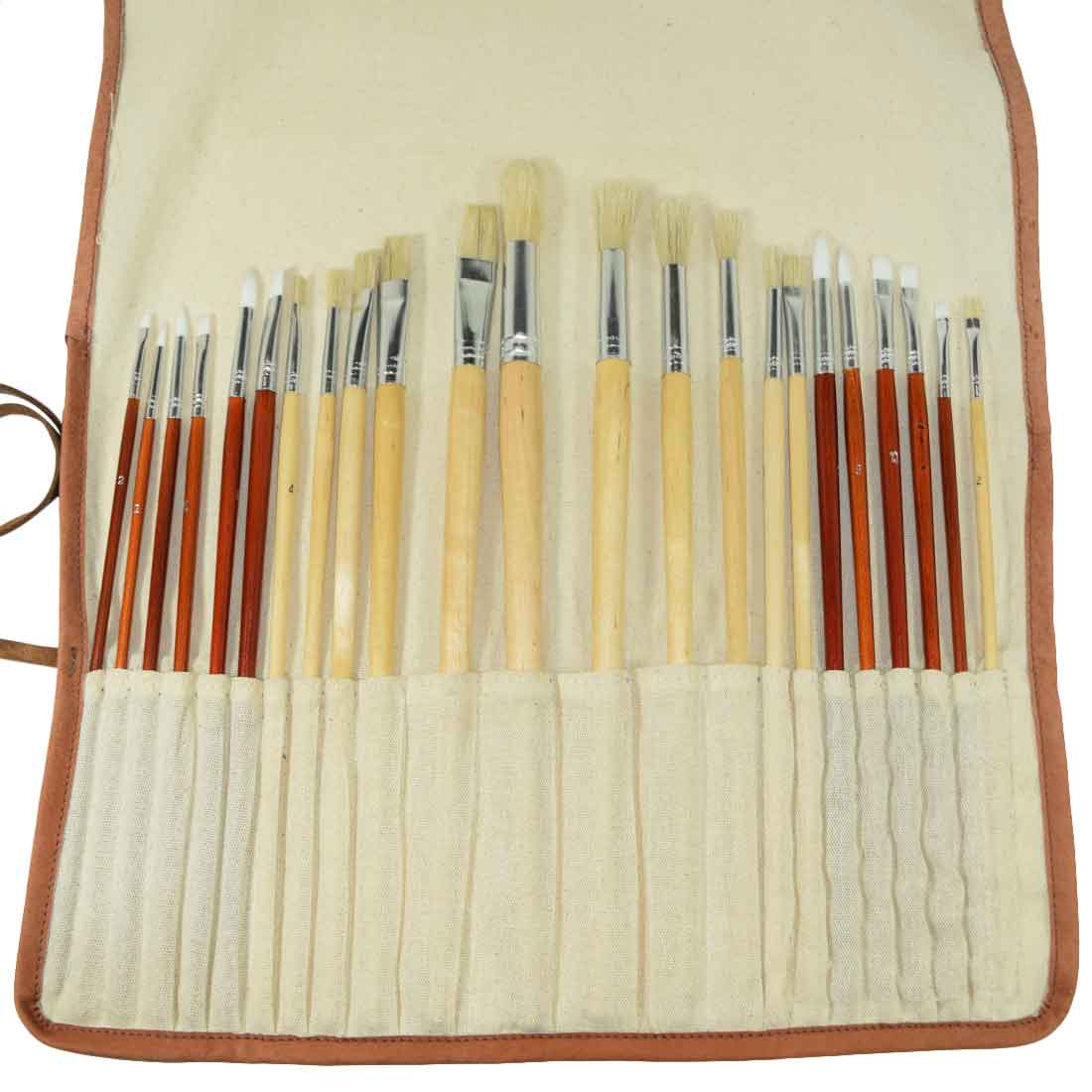 Detailed view of the Paint Brush Roll-Up by Hide & Drink containing a variety of brushes elegantly stored. This Artist Paint Brush Canvas Roll-Up with Leather Lining Storage Wrap / 24 Slots / Workshop Art Study demonstrates superior craftsmanship through small batch production. Fire branded and artisan-made in La Antigua Guatemala & Oaxaca Mexico.