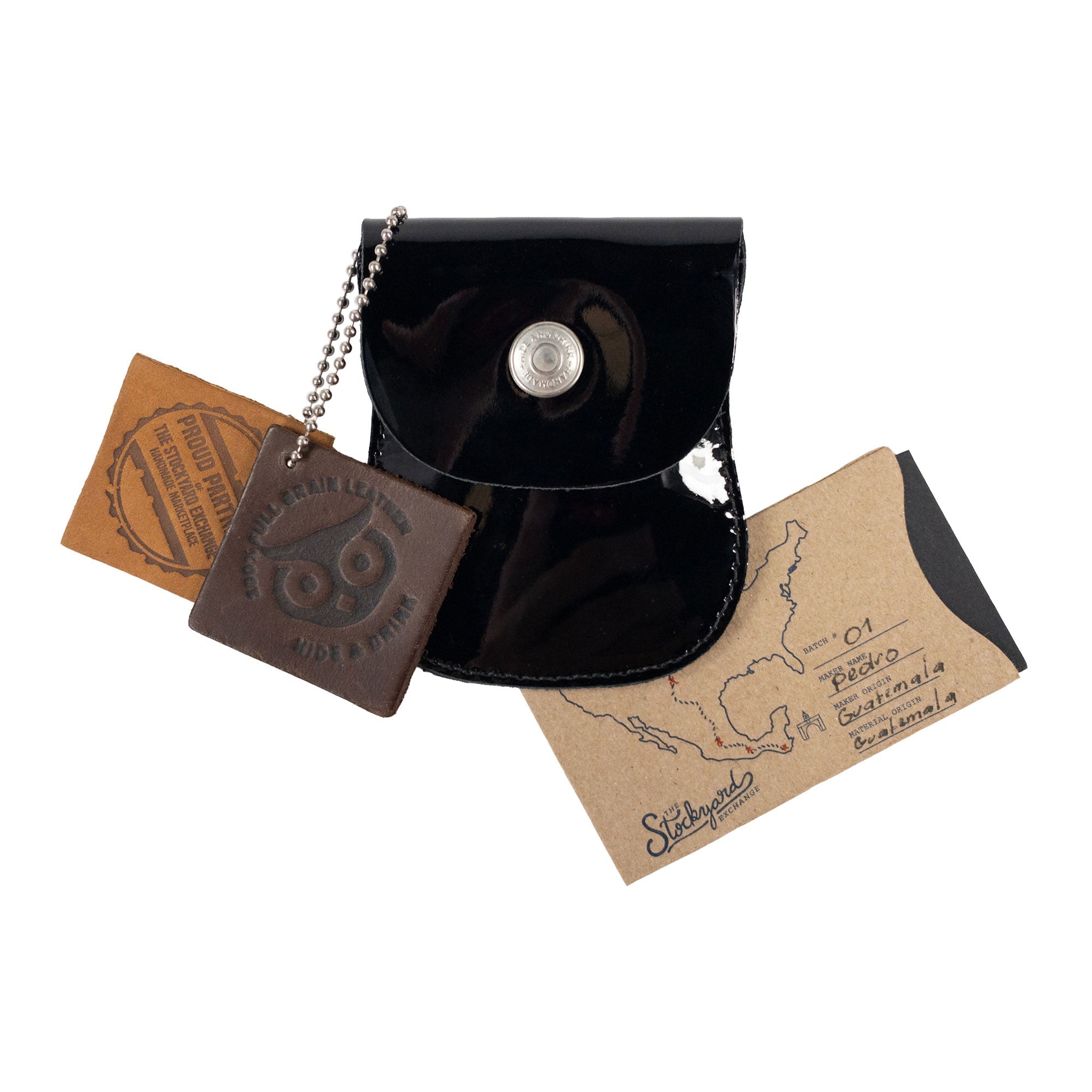 Curvy Coin Pouch by Hide & Drink with business cards and a keychain, underlining its stylish and functional design for organization as a travel accessory.