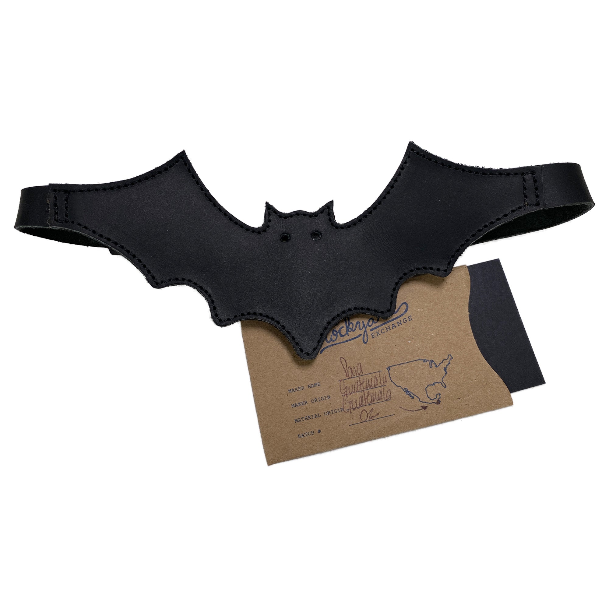 Profile view of the Bat-man Choker by Hide & Play, paired with its packaging, displaying its artisan quality. This Bat Choker serves as a trendy accessory that showcases small batch production and carefully crafted leatherwork.