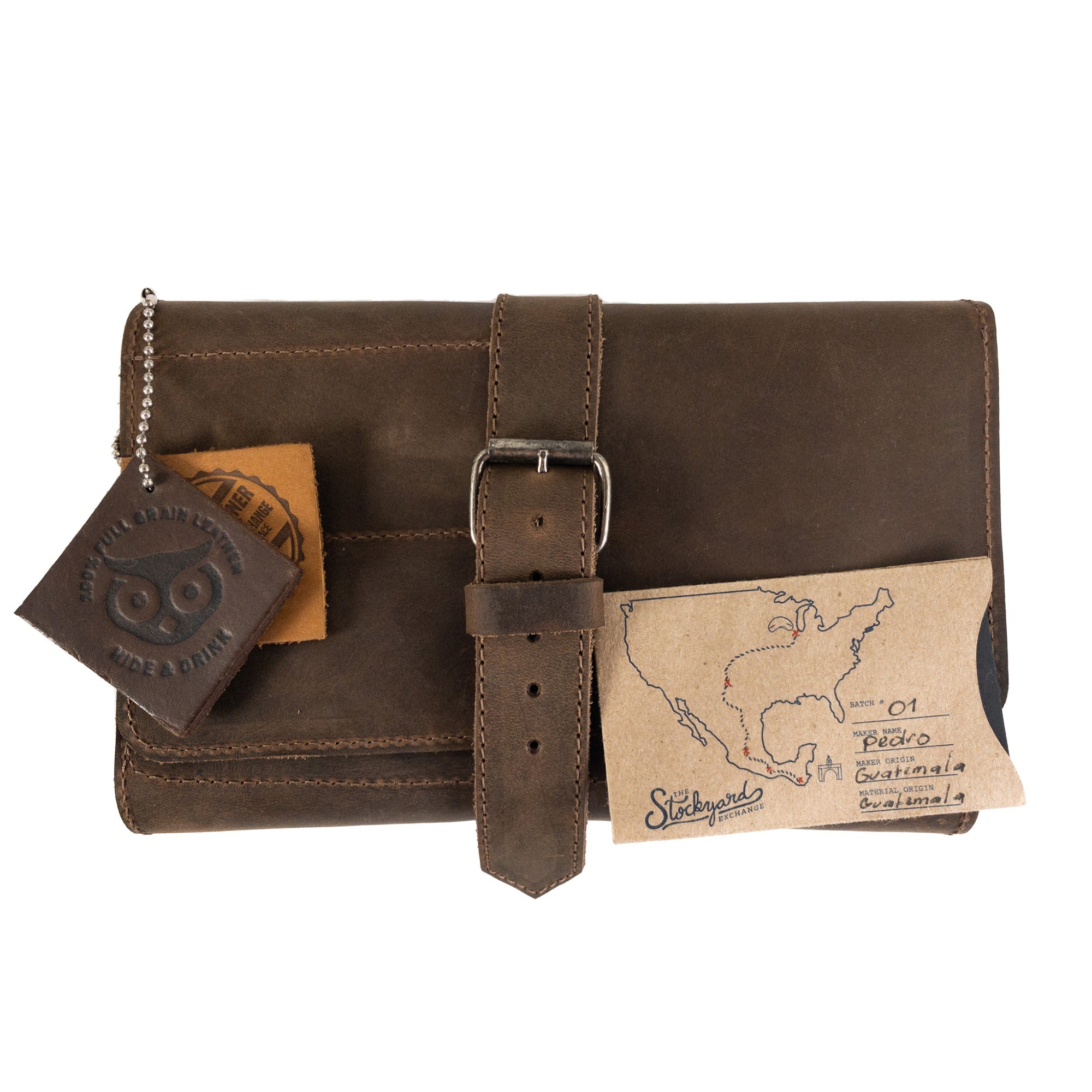 Front view of the brown Hide & Drink Double Pipe Tobacco Pouch complete with a tag highlighting its artisan craftsmanship and small batch production. Perfect for storing pipe tobacco.