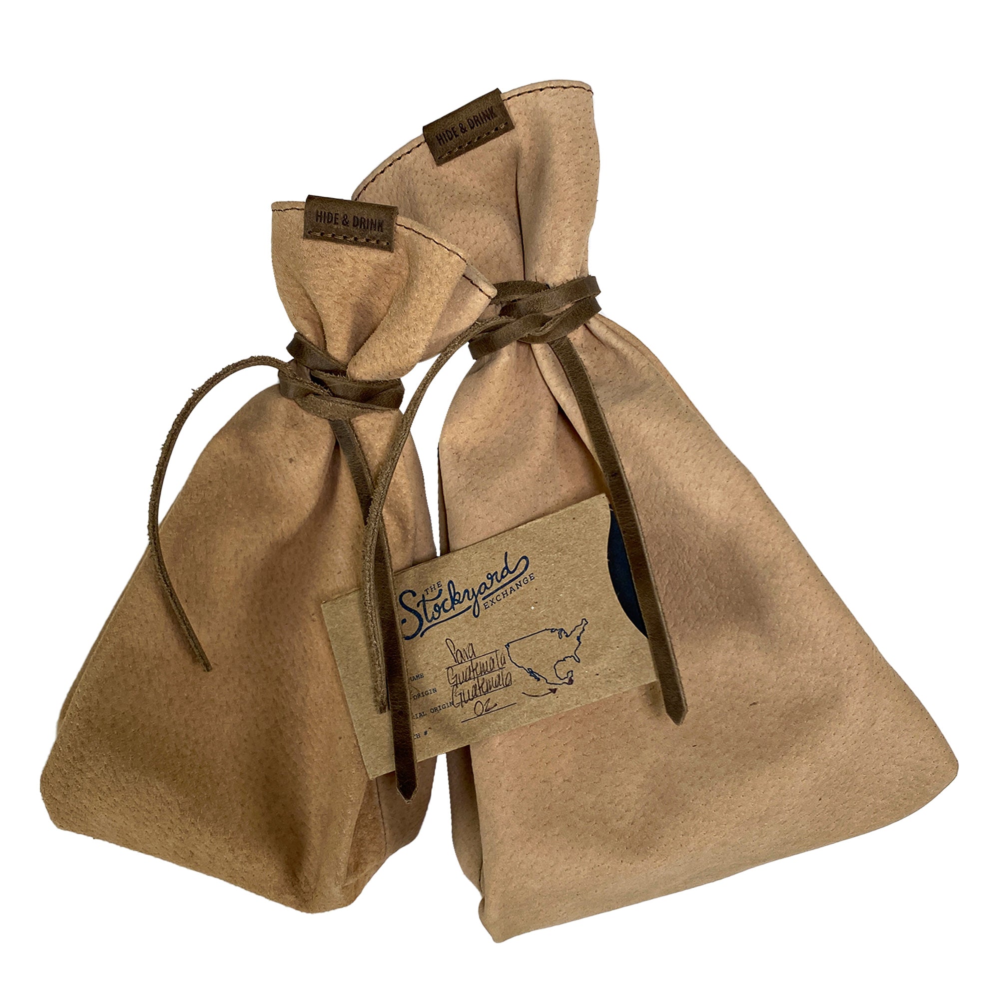 Presenting Hide & Drink's Drawstring Sack (2 pack) with tags, emphasizing its unique design that makes it a thoughtful gift option. Drawstring Sack (2 pack) Handmade from Sheepskin and Full Grain Leather, StockyardX, Small Batch Production, Hand Cut, Hand Sewn, Fire Branded, Artisan, Handmade in La Antigua Guatemala & Oaxaca Mexico.