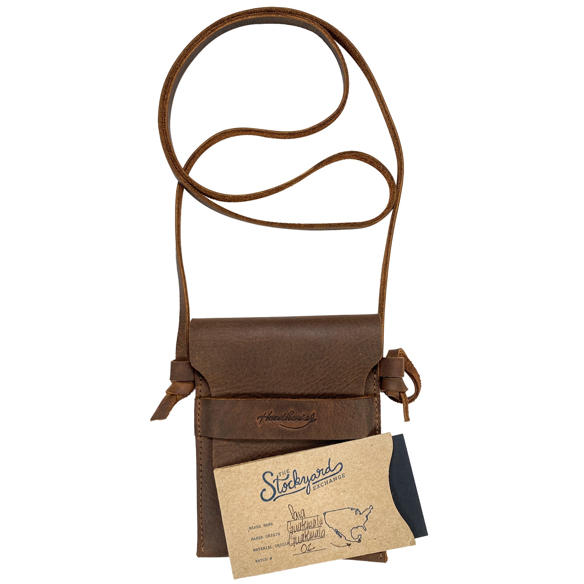 Packaging of the Mini Travel Bag by Heather's with a thank you card included, emphasizing its artisanal approach. This Mini Travel Bag Handmade from Full Grain Leather is a classic organizer, coin pouch, and storage case for ID, credit cards, and cash. StockyardX, Small Batch Production, Hand Cut, Hand Sewn, Fire Branded, Artisan, Handmade in La Antigua Guatemala & Oaxaca Mexico.