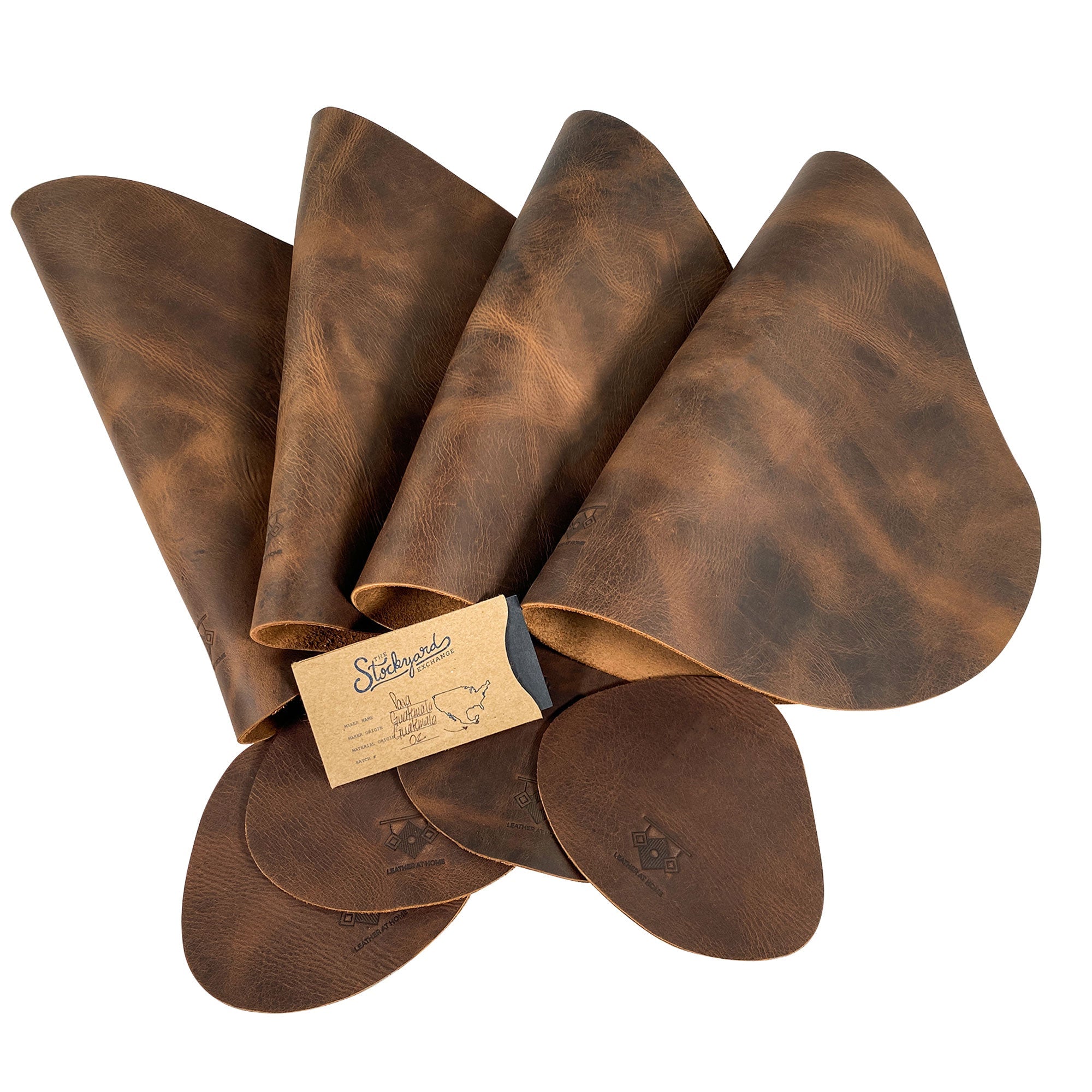 Leather Place Mats with Coasters Set of 4 by Leather At Home, neatly organized with branding tag. Showcasing the exquisite craftsmanship and rustic aesthetic of handmade full grain leather, these decorative kitchen table mats are essentials you‚Äôll cherish, made in La Antigua Guatemala & Oaxaca Mexico.