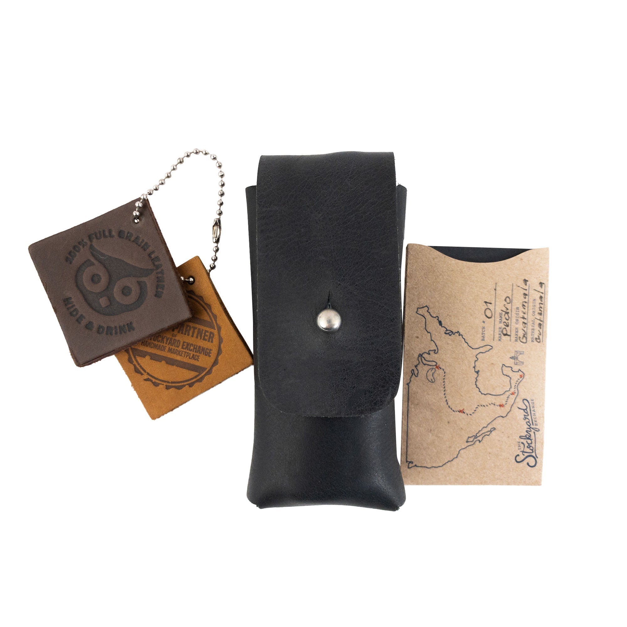 Hide & Drink Knife Case with accessories, revealing its premium black full grain leather craftsmanship. This riveted Swiss knife case is an essential holster for cooking or camping, handmade by skilled artisans in La Antigua Guatemala.