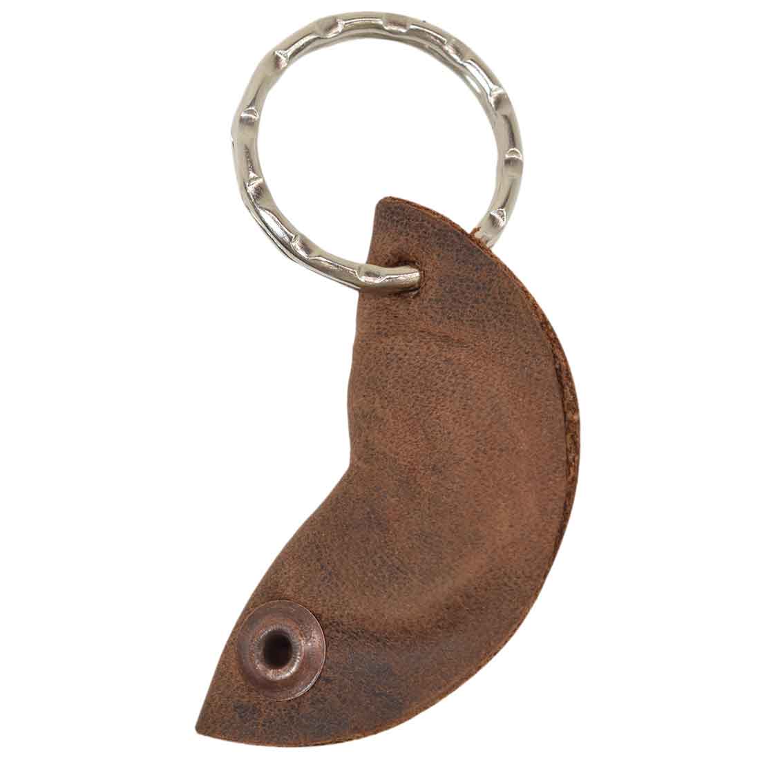 Close-up of the Fidget Cashew Keychain by Hide & Drink, highlighting the Full Grain Leather finish. This charming key holder serves as a Good Luck Charm and is crafted through small batch production. Each keychain is hand cut, hand sewn, and fire branded, emphasizing the artisan quality from La Antigua Guatemala & Oaxaca Mexico.